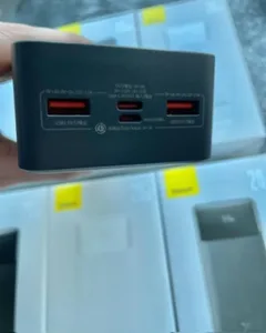 a hand holding a black power bank